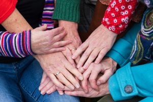 group of people of with their hands together