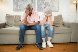 elderly couple both stressed out