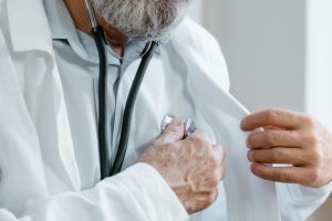 a doctor checking their own heart rate