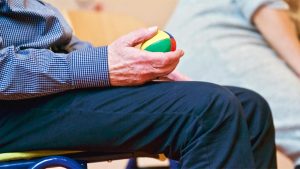 pexels-matthiaszomer-339619 senior man holding a stress ball